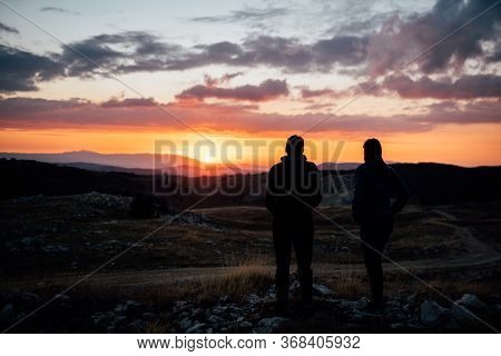 Young Backpacker Hiker Couple Enjoying Relaxing Mountain Hike At Sunset.active Hiking Camping Trip V