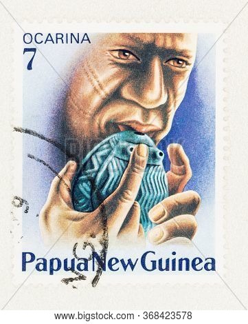 Seattle Washington - May 25, 2020:  Man Playing Native Wind Instrument, Ocarina, On 1979 Papua New G