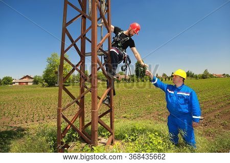 Two Tehnicians Are Working On Power Transmission Line