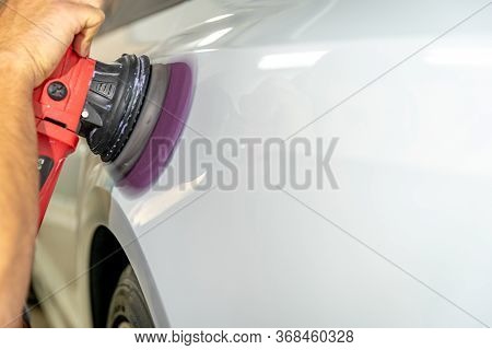 Polishing The Car Body With A Manual Automatic Grinder With Wax And Polishing Paste