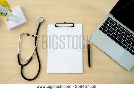 Check For Care Concept. Top View Of Doctor Working Place With , Stethoscope, And Blank Paper On Clip