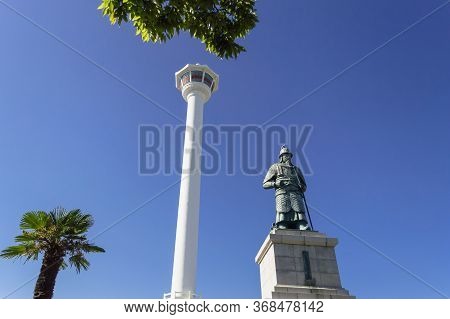 Busan, South Korea, September 14, 2019: View Of Busan Tower With Statue Of Yi Sun-sin In Front Of It