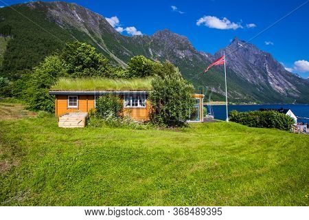 Picturesque Scene Of Urke Village And Hjorundfjorden Fjord, Norway. Drammatic Sky And Gloomy Mountai