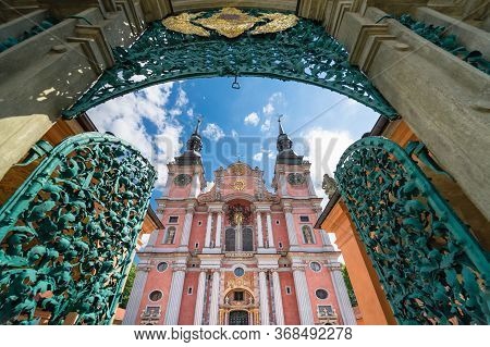 The Opened Magnificent Openwork Metal Entry Gate And Beautiful Facade Of Baroque Basilica Of The Vis