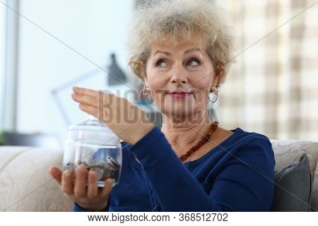 Portrait Of Senior Charming Woman Holding Glass Container For Money. Elderly Female And Piggy Bank F