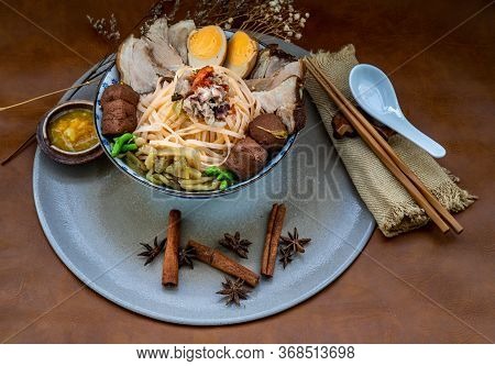 Traditional Chinese Sliced Stewed Pork Noodles With Pork Bone Broth And Boiled Egg, Tofu In Ceramic 