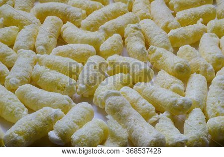 Airy Crisps, Corn Puffs, Puffcorn Snacks Background. Detailed Shot Of Ready-to-eat Puffcorn. Crispy 