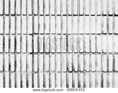 White Vertical Masonry Brick Wall With Dirty And Black Stains.