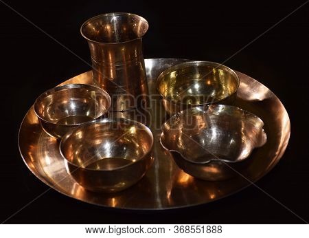 Empty Brass Utensils Isolated In Dark Background. Brass Is Also Called As Peetal In Hindi Language. 