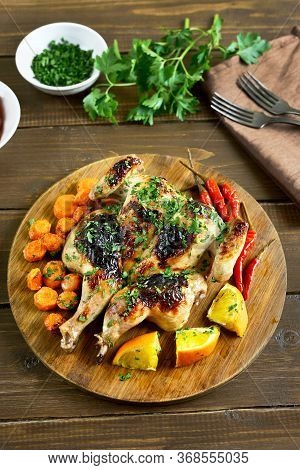Grilled Spatchcock Chicken With Vegetables On Wooden Table