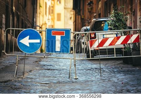 Road Works Detour Road Signs. Dead End Road And Arrow To Turn Left. Iron Crossing Barrier. Street Wi