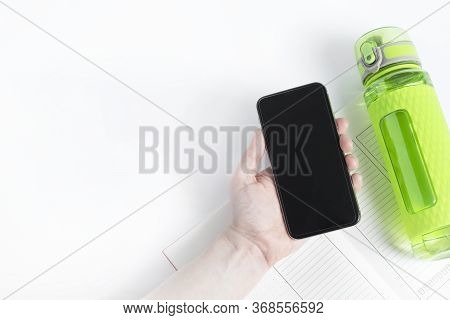 One Bright Green Fitness Sport Bottle Or Flask With Dispenser And Filled With Water. Smartphone Gadg