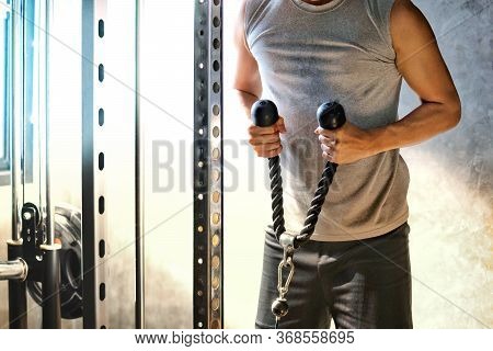 Muscular Fitness Asian Man Holding Rope Cable In Training At Gym Background.cross Fit Bodybuilder St