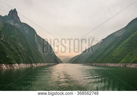 Wushan, Hubei, China - May 7, 2010: Wu Gorge In Yangtze River. Long View With Orange Lighted Sky Ove