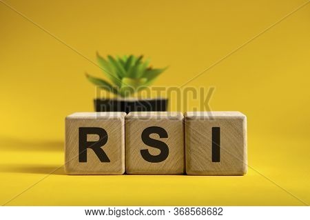 Rsi - Conceptual Text On Wooden Cubes On A Bright Background And A Black Pot With A Flower Behind