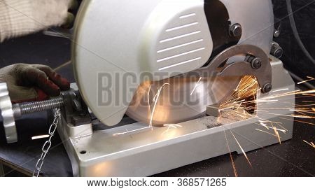 Grinding In Steel Manufactory. Working Man With Big Saw Cutting Metal. Dangerous And Hard Work Conce