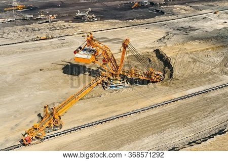 Huge Bucket Wheel Excavator Or Mobile Strip Mining Machine Mining Coal In A Quarry. Heavy Industry C