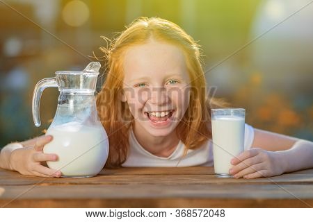 Red-haired Girl, With Blue Eyes, Laughs Showing Strong White Teeth, Against A Sunny Morning. Fresh M