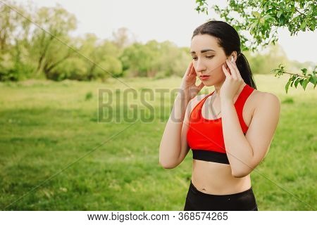 Female Runner Seting Up Music On Her Phone During Morning Workout. Outdoor Sports. Exercises For Ton