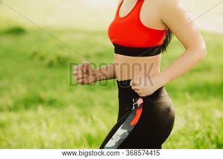 The Girl Runs On The Green Grass On The Sunny Day. Outdoor Sports. Exercises For Tonus, Flexibility 