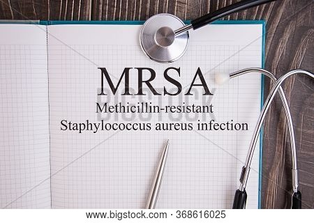 Notebook Page With Text Mrsa Methicillin-resistant Staphylococcus Aureus Infection, On A Table With 
