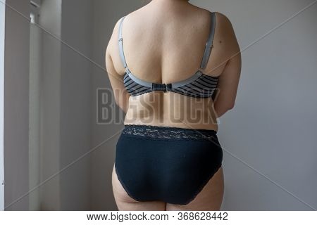 Woman Real Body Plus size Model in lingerie posignand showing fat back, imperfect nonideal