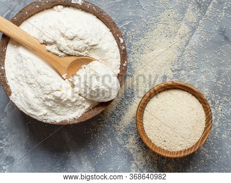 Raw Fonio Flour And Seeds With A Spoon On Grey Background Top View. Alternative Flour