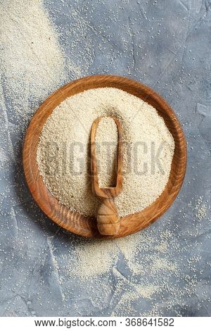 Raw Uncooked Fonio Seeds With A Spoon On A Plate On Grey Background Top View With Copy Space