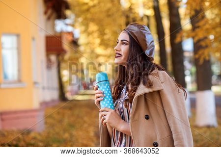 Pretty Brunette Woman Is Holding Termo Mug In Her Hands. Autumn Season.
