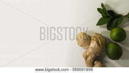Close-up Of Ginger Root, Mint Leaves And Lime Fruits. Healthy Drink. Tea Supplement. Cold Remedy. He