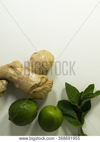 Close-up Of Ginger Root, Mint Leaves And Lime Fruits. Healthy Drink. Tea Supplement. Cold Remedy. He