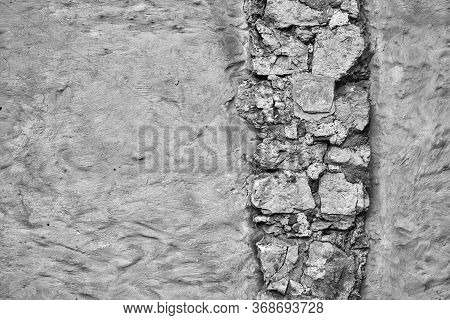 Empty Monochrome Surface Of Old Plastered Wall For Background With Textured Vertical Piece Of Masonr
