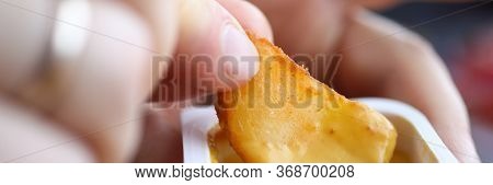 Close-up Of Male Hand Holding Dipping Potatoes And Sauce In Plastic Container. Yummy Snack For Quick