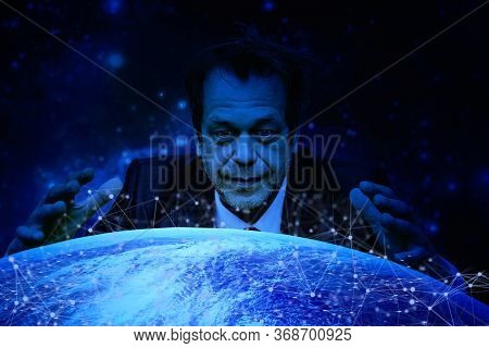 A Man With A Crazy Look On His Face Was Inclined Over The Globe Spreading His Arms. Concept:world Do