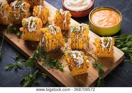 Sweet corn slices grilled and spiced as healthy party food alternative