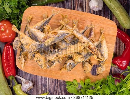 Tasty Fried Trachurus On A Wooden Board, Top View