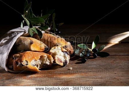 Traditional Italian Puccia Breads With Black Olives In A Cotton Bag, Made In Salento, Puglia On A Wo