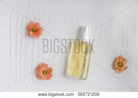 Glass, Cosmetic Bottle On White Background With Water And Flowers. Top View, Closeup