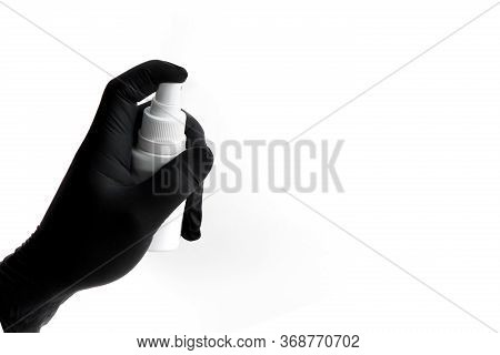 Hand In Black Nitrile Glove Holds Spray For Disinfection. Free Space For Text