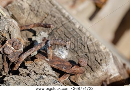 There Are Rusty Attachment Nails And Iron On The Board.