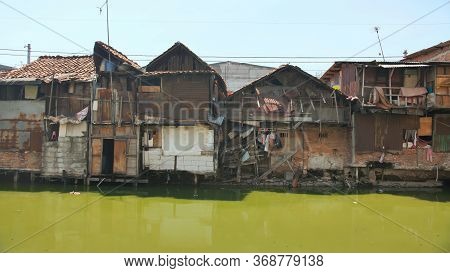Slum Area On The Riverbank In Jakarta. Indonesia.
