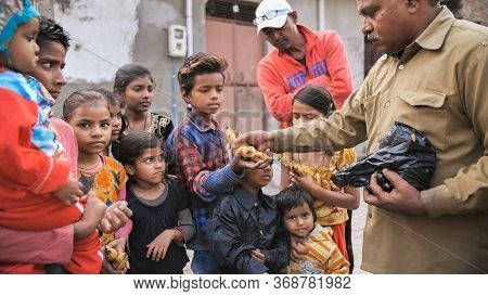 Agra, India - December 12, 2018: Banana Treats For Children From Poor Areas Of Agra City.