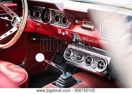 Retro Interior Of Old Automobile, Steering Wheel And Dashboard In Historic Vintage Red Car. Old Vehi