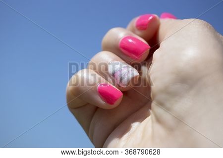 Womans Hand Showing Her Semipermanent Manicure. Pink Colour