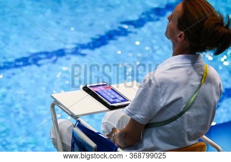 Kyiv, Ukraine - August 9, 2019: Diving Referee In Action During The Mixed 10m Synchro Final Of The 2