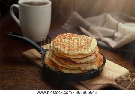 Delicious Sweet Pancakes In A Hot Pan On The Table. Gourmet Breakfast.