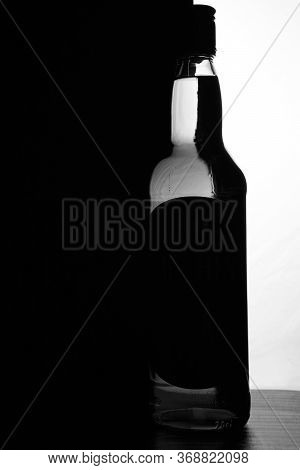 A Bottle Of Whiskey On A Black And White Background. Optical Effect