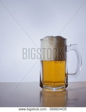 Silhouette Of A Beer Mug With Amber Yellow Beer, Which Is Poured With Foam