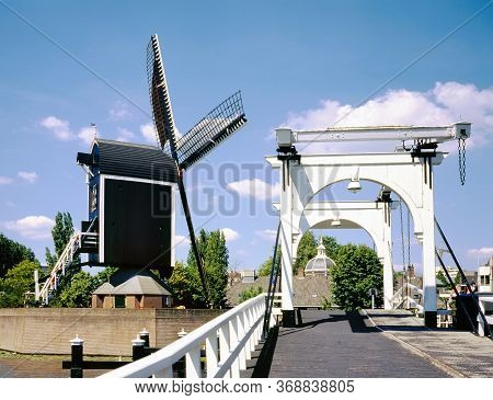 Rembrandt Bridge Over The Rijn Looking Towards The Molen De Put Windmill And At Background The Small
