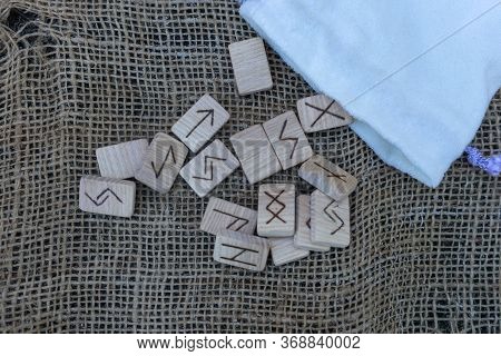 Scandinavian Wooden Runes On An Old Wooden Table. Elder Futhark.